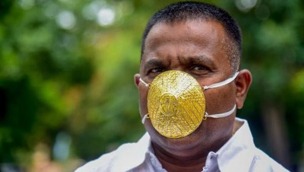 This Indian man is wearing a gold-plated mask