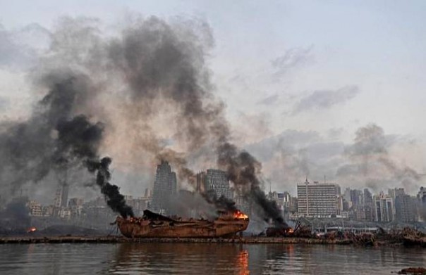 Black smoke and a burning wreck in a large explosion incident at the Port of Beirut, Lebanon.